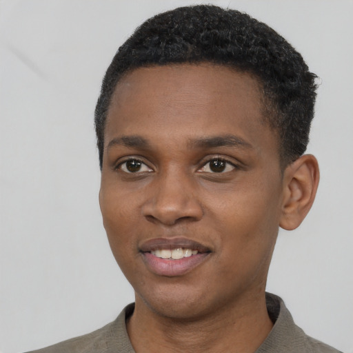 Joyful black young-adult male with short  black hair and brown eyes