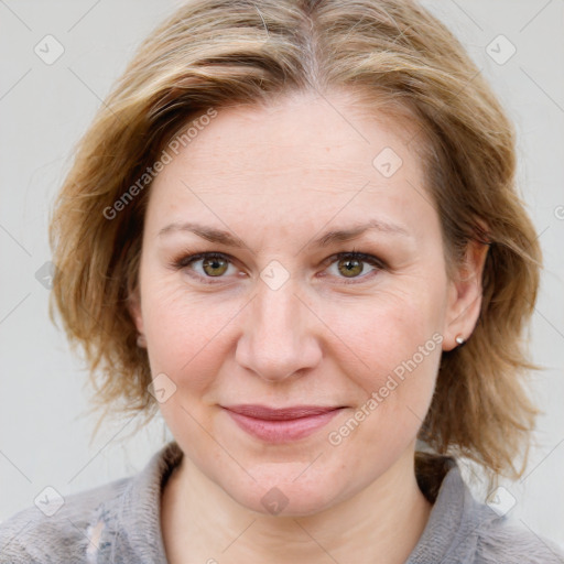 Joyful white adult female with medium  brown hair and blue eyes