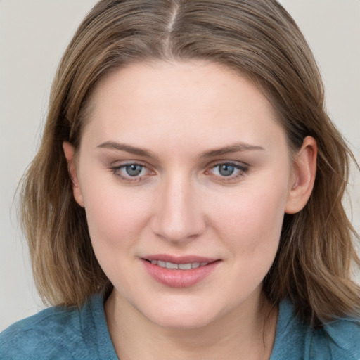 Joyful white young-adult female with medium  brown hair and blue eyes