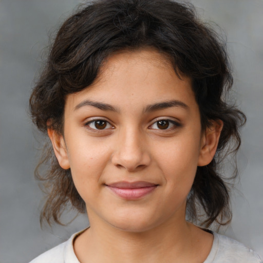 Joyful latino child female with medium  brown hair and brown eyes