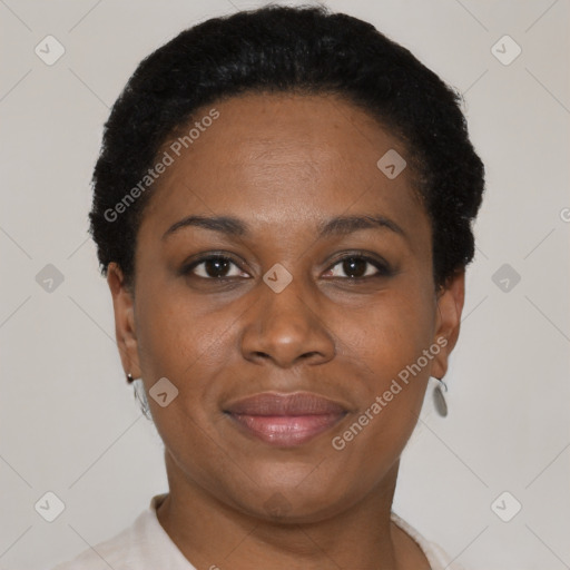 Joyful black adult female with short  black hair and brown eyes
