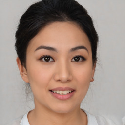 Joyful asian young-adult female with medium  brown hair and brown eyes