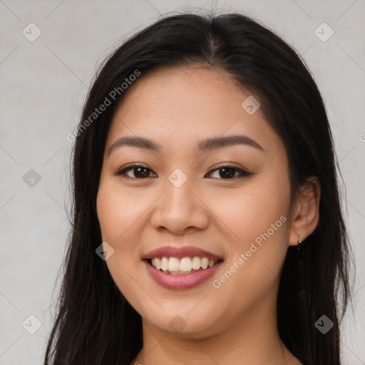 Joyful latino young-adult female with long  brown hair and brown eyes