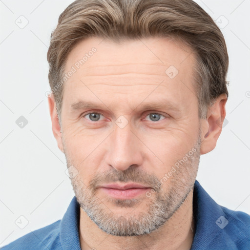 Joyful white adult male with short  brown hair and grey eyes