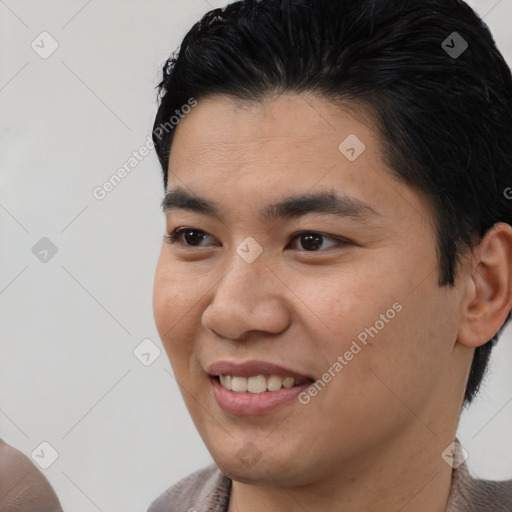 Joyful latino young-adult male with short  brown hair and brown eyes