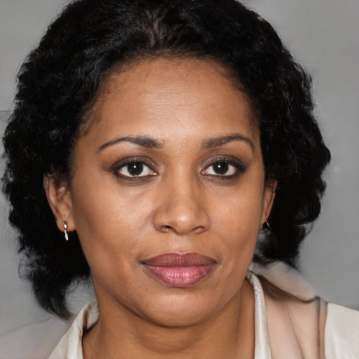 Joyful black adult female with medium  brown hair and brown eyes