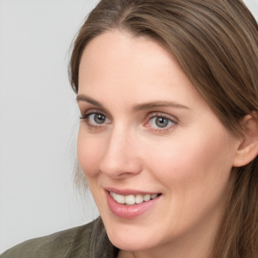 Joyful white young-adult female with long  brown hair and grey eyes