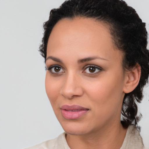 Joyful black young-adult female with medium  brown hair and brown eyes