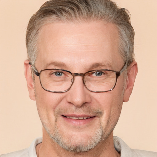 Joyful white middle-aged male with short  gray hair and brown eyes