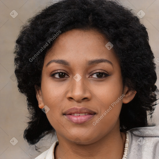 Joyful black young-adult female with long  black hair and brown eyes