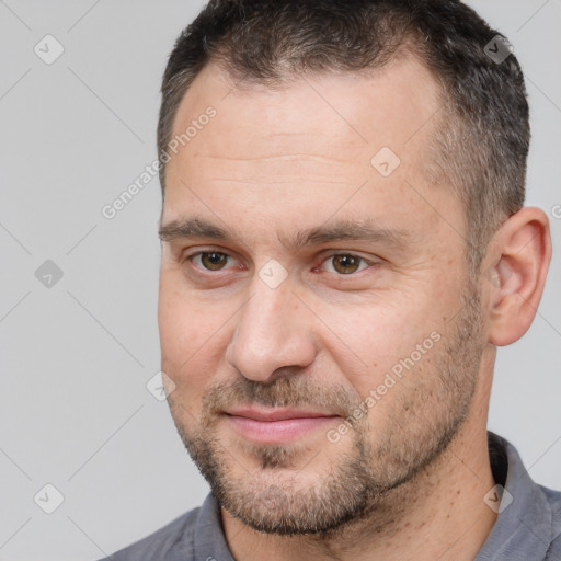 Joyful white adult male with short  brown hair and brown eyes