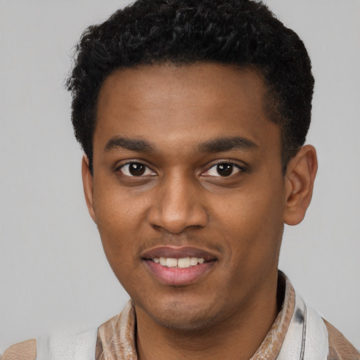 Joyful latino young-adult male with short  brown hair and brown eyes