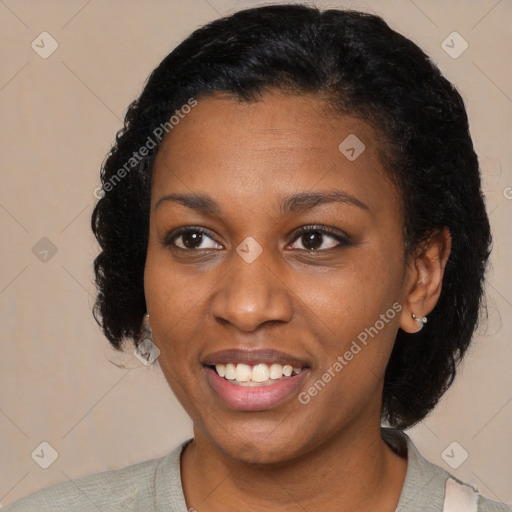 Joyful black young-adult female with short  black hair and brown eyes