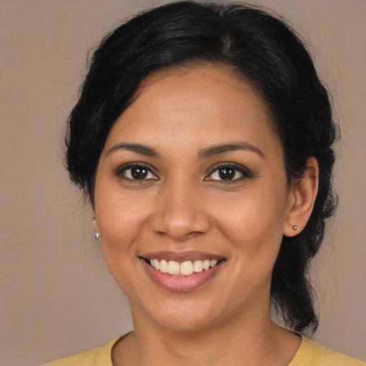 Joyful latino young-adult female with medium  brown hair and brown eyes