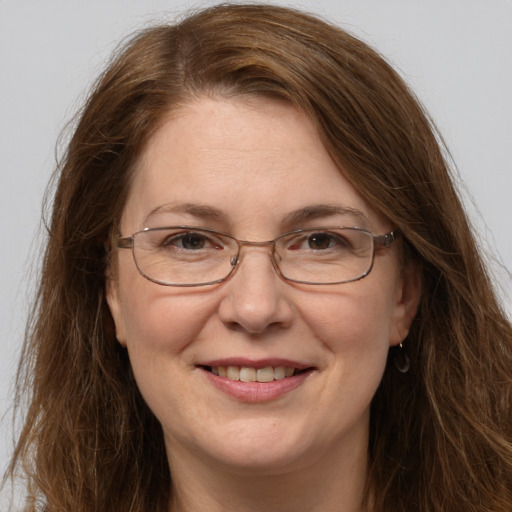 Joyful white adult female with long  brown hair and grey eyes