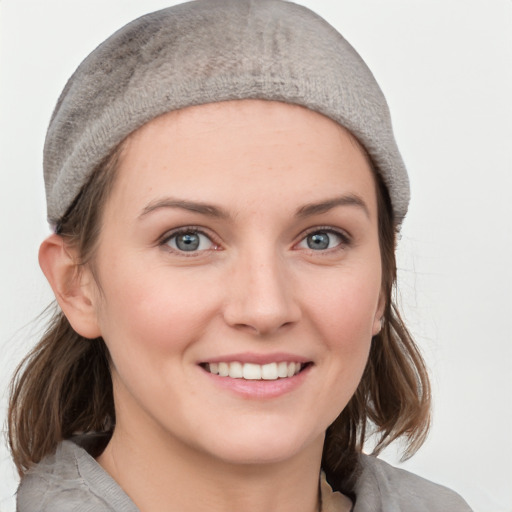 Joyful white young-adult female with medium  brown hair and blue eyes