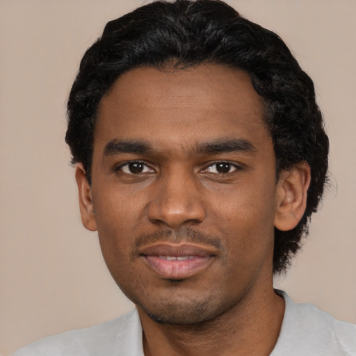 Joyful black young-adult male with short  black hair and brown eyes