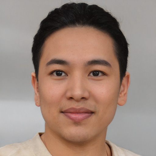 Joyful asian young-adult male with short  brown hair and brown eyes