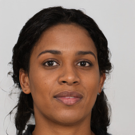 Joyful black young-adult female with medium  brown hair and brown eyes