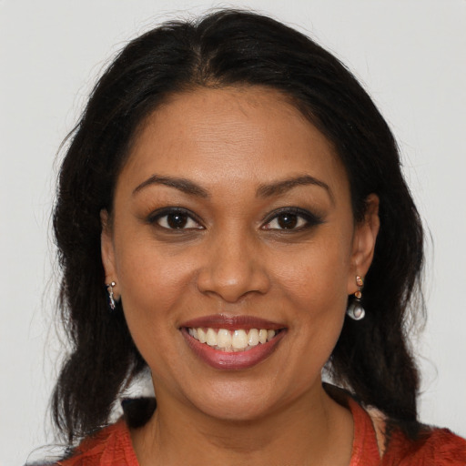 Joyful black adult female with medium  brown hair and brown eyes