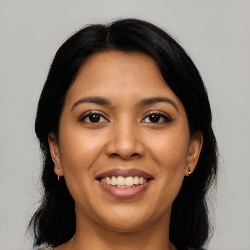 Joyful latino young-adult female with long  black hair and brown eyes