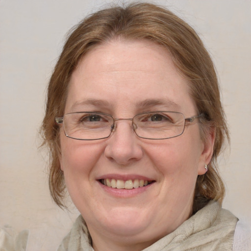 Joyful white middle-aged female with medium  brown hair and blue eyes