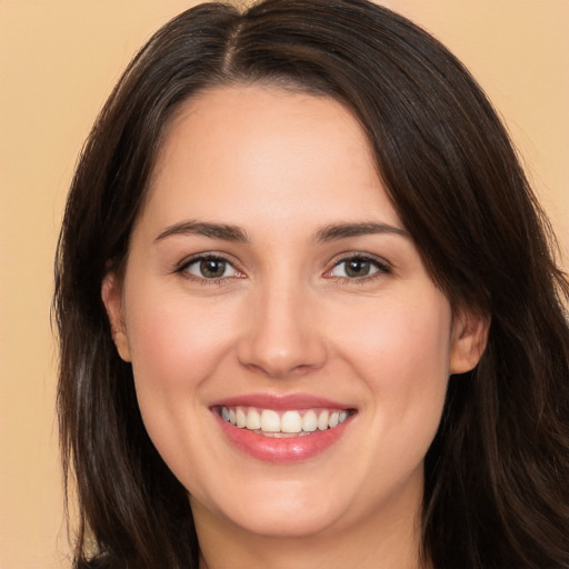 Joyful white young-adult female with long  brown hair and brown eyes