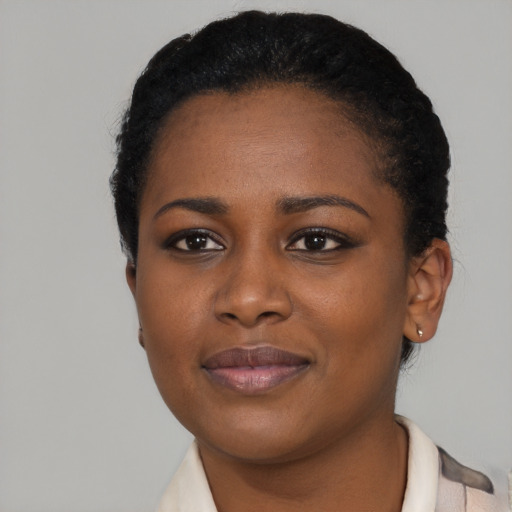 Joyful black young-adult female with short  brown hair and brown eyes