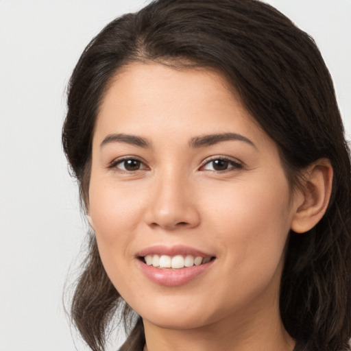 Joyful white young-adult female with long  brown hair and brown eyes