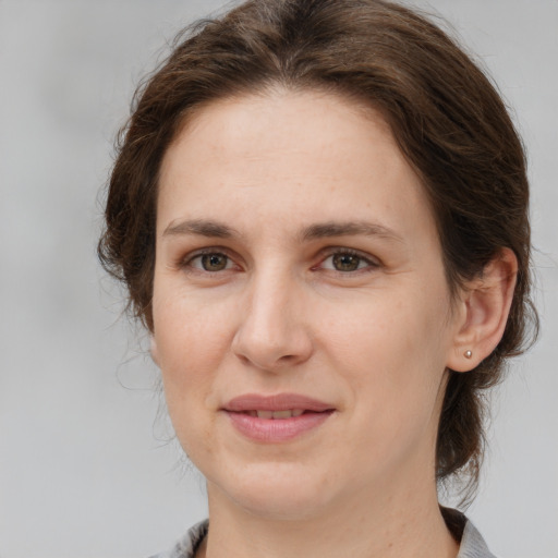 Joyful white adult female with medium  brown hair and brown eyes