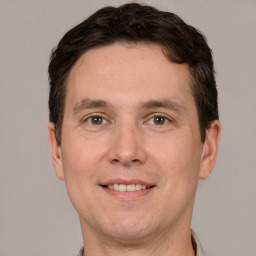 Joyful white adult male with short  brown hair and grey eyes