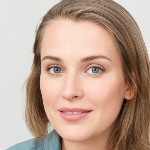 Joyful white young-adult female with long  brown hair and blue eyes