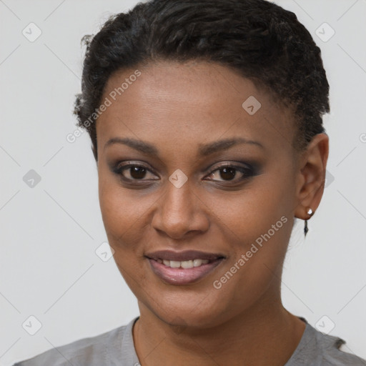 Joyful black young-adult female with short  brown hair and brown eyes