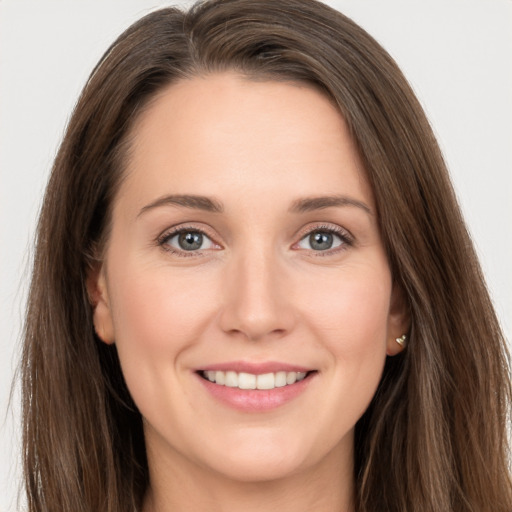 Joyful white young-adult female with long  brown hair and grey eyes