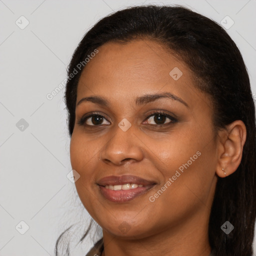 Joyful black young-adult female with long  brown hair and brown eyes