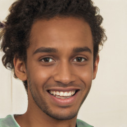 Joyful black young-adult male with short  brown hair and brown eyes