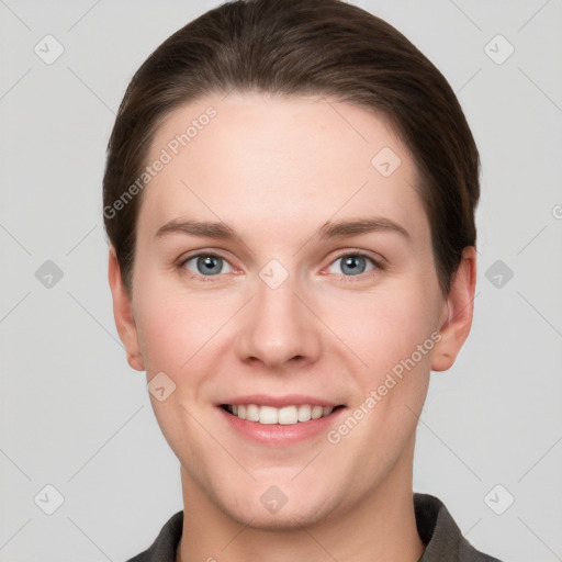 Joyful white young-adult female with short  brown hair and grey eyes