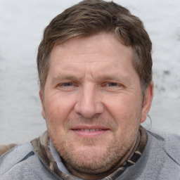 Joyful white adult male with short  brown hair and grey eyes