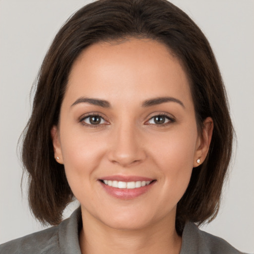 Joyful white young-adult female with medium  brown hair and brown eyes