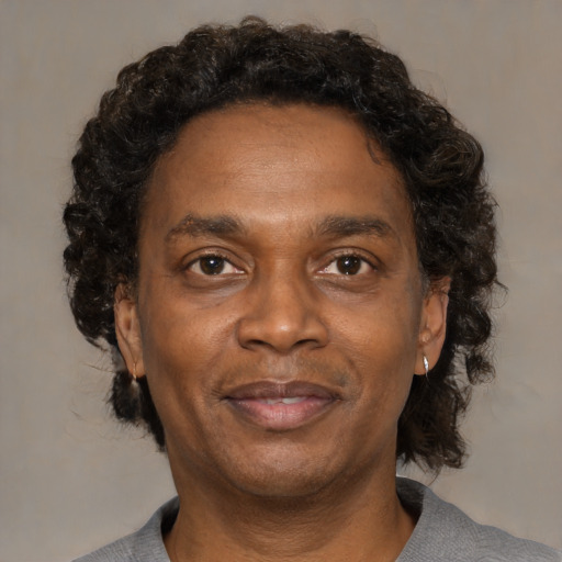 Joyful black adult male with short  brown hair and brown eyes
