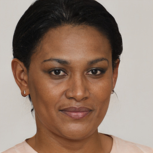 Joyful black adult female with short  brown hair and brown eyes