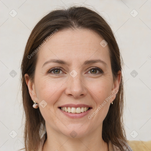 Joyful white adult female with medium  brown hair and grey eyes