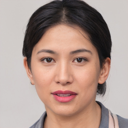 Joyful white young-adult female with medium  black hair and brown eyes