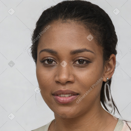 Joyful black young-adult female with long  black hair and brown eyes