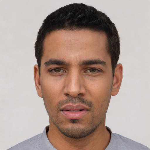 Neutral latino young-adult male with short  black hair and brown eyes