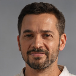 Joyful white adult male with short  brown hair and brown eyes