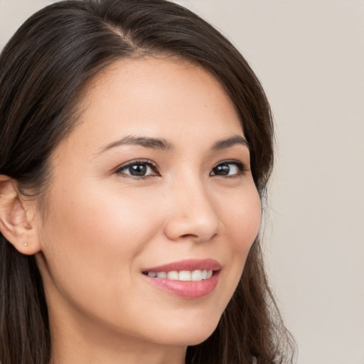 Joyful white young-adult female with long  brown hair and brown eyes