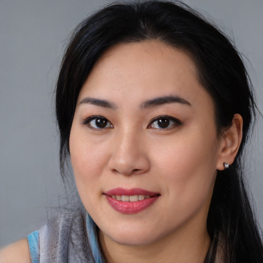 Joyful asian young-adult female with long  brown hair and brown eyes