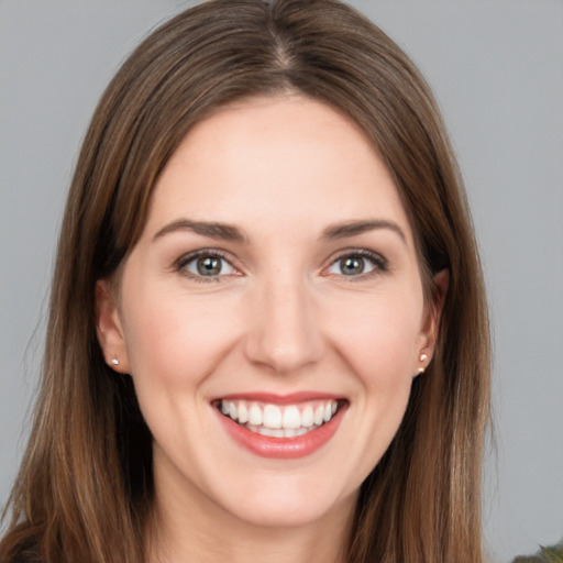 Joyful white young-adult female with long  brown hair and grey eyes