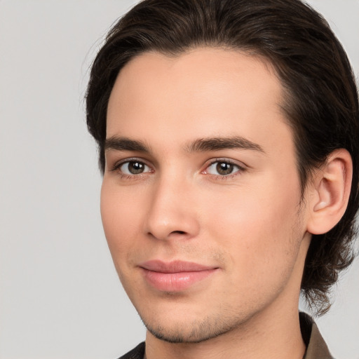 Joyful white young-adult male with medium  brown hair and brown eyes